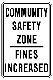 Image of a white and black sign reading, community safety zone, fines increased.