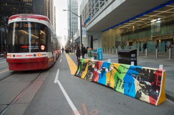 Decorated concrete barriers mark out where transit riders should wait for streetcars.
