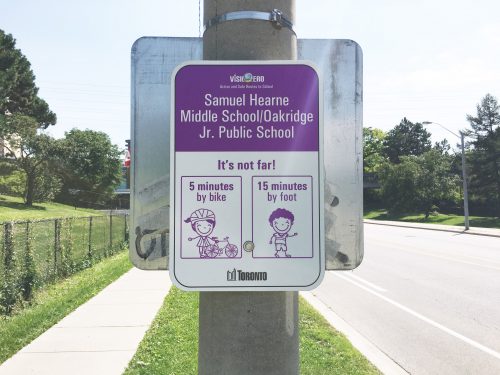 Signage in purple reading Vision Zero, Active and Safe Routes to School, Samuel Hearne Middle School/Oakrdge Jr. Public School, It’s not far! 5 minutes by bike, 15 minutes by foot.