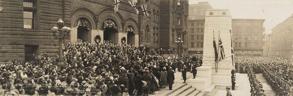 Lord Byng unveiling Old City Hall cenotaph, surrounded by large group of soldiers, civilians and government officials