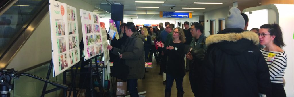 A number of people reviewing Open House panels and in conversation with City Staff