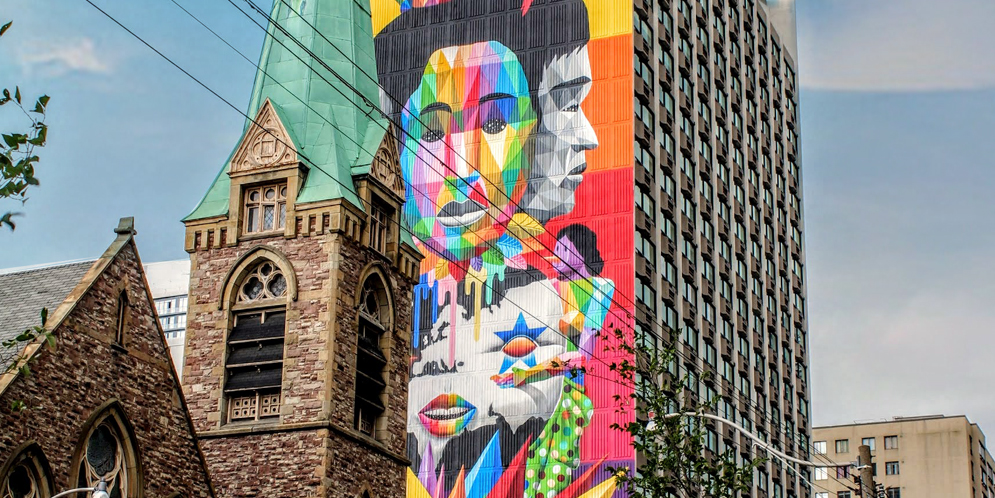 colourful geometric-shaped mural on side of high-rise building