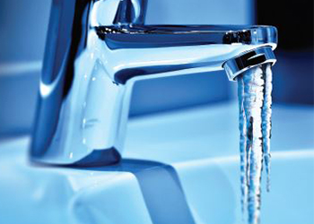 water faucet with frozen icicle coming out