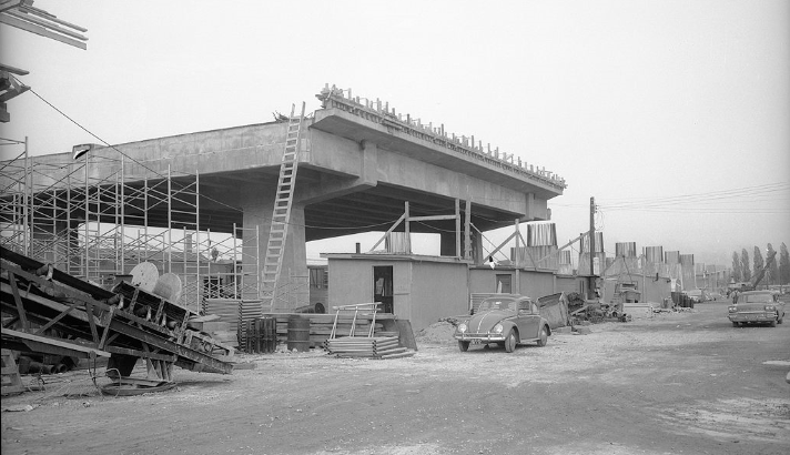 Cars drive by a partially built Gardiner Expressway in this photo from the late 1950s