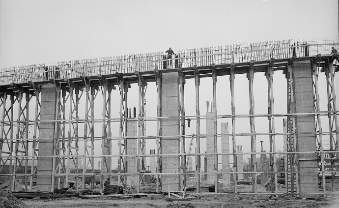 Construction workers can be seen working on top of a highway bent during the construction of the Gardiner 