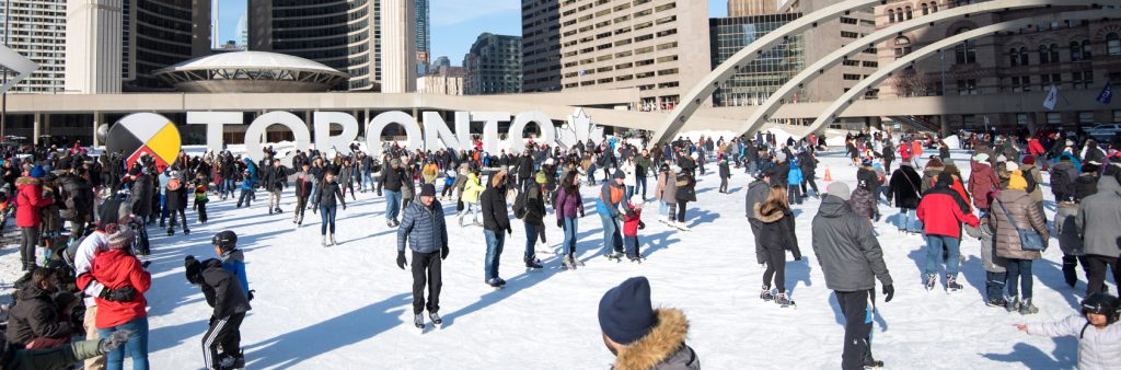 People skating on Nathan Phillips Square during a sunny Family Day