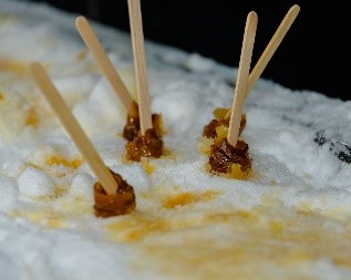 Maple taffy on snow - with sticks