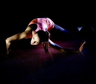 dancer, contorted, on hands and knees.