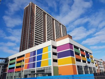 Multi-coloured building on a sunny cloudy day.