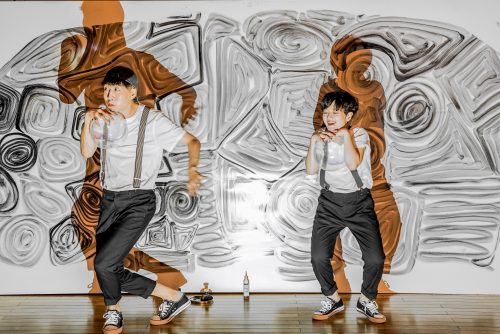 two people dancing. black, white and orange background