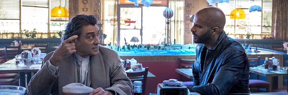 Actors Ian McShane and Ricky Whittle sit in diner.