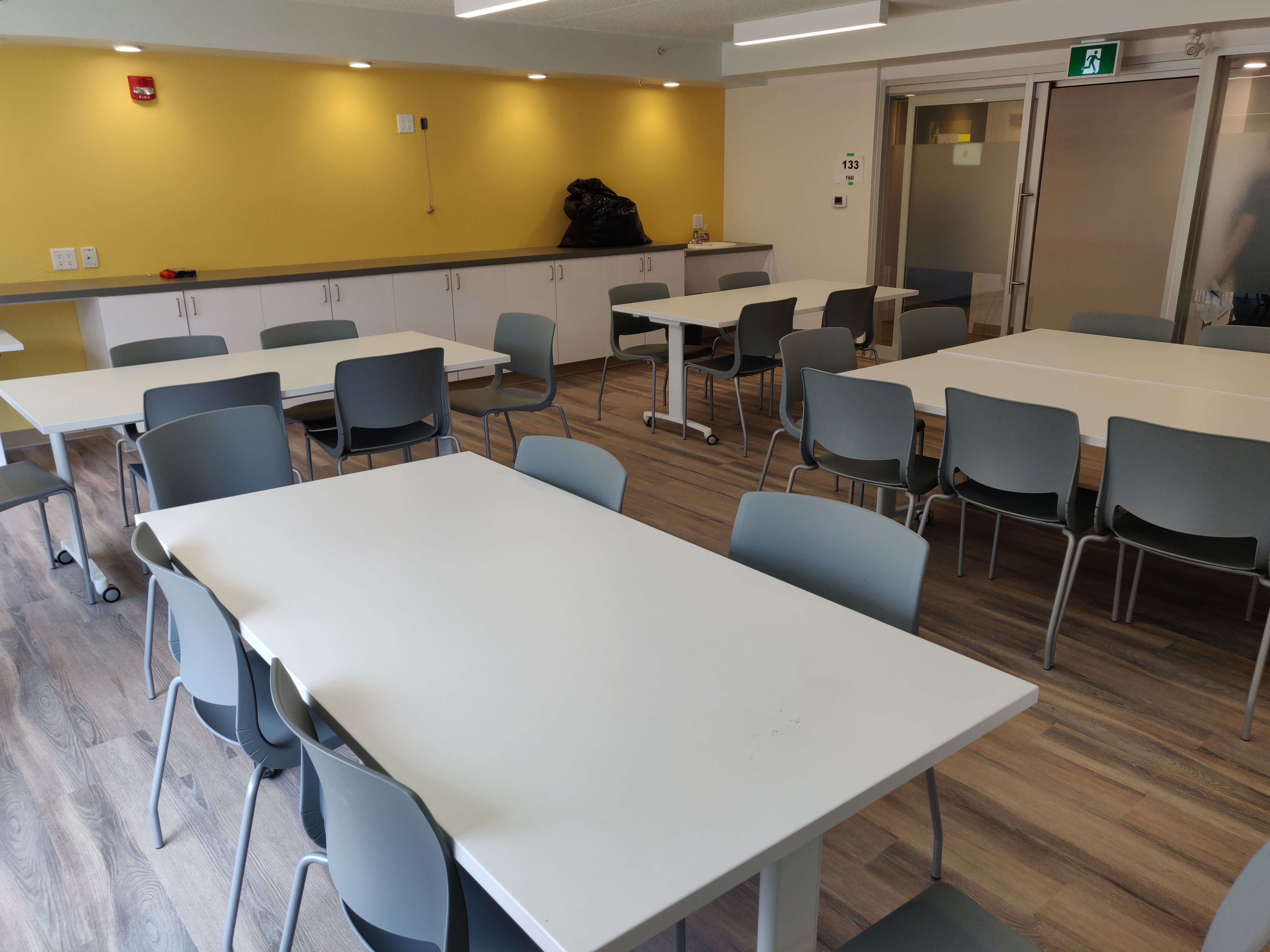 LArge spacious room with tables and chairs at a new shelter