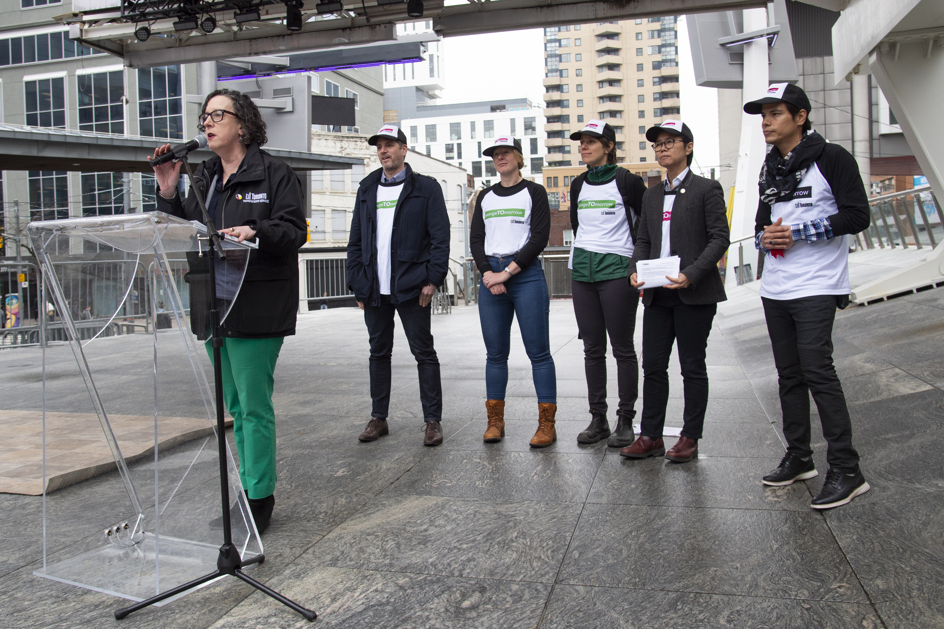 Barbara Gray, GM of Transportation Services giving a speech with staff behind her on stage at the yongeTOmorrow launch event