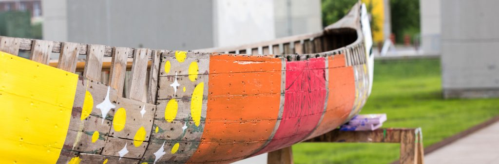 Colourfully-decorated wooden canoe