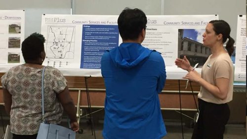 Participants viewing display boards and discussing the Community Service Facilities strategy with City staff at the Keele Finch Plus public consultation