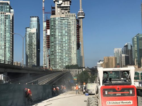 Image of westbound Gardiner Yonge-Bay-York off-ramp work zone, image of crews chipping concrete on the southside of the ramp.