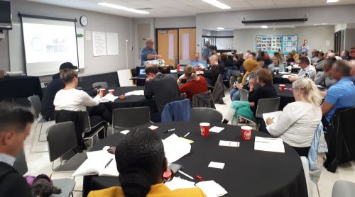 A group of residents together at a local Community Liaison Committee discussing issues and solutions relating to shelter operations