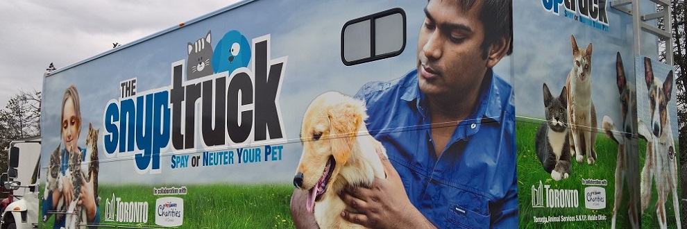 A branded mobile veterinary clinic, the "Spay-Neuter Your Pet” truck