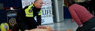 Paramedic demonstrating AED during a training session