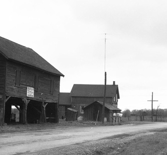 Grayscale photo of Keele Street and Finch Ave in 1955, with dirt roads and historical properties