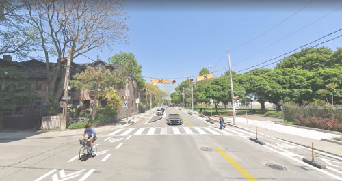 This image is an artist rendering of Shuter Street with separated bike lanes (cycle tracks) in each direction. It shows the location of parking on one side of the street, between the bike lane and the traffic lane.