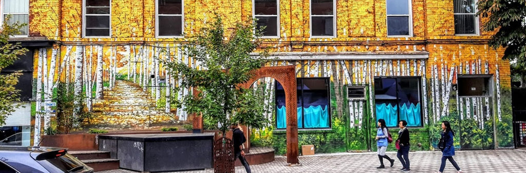 Photo of a mural depicting birch trees on the side of a building