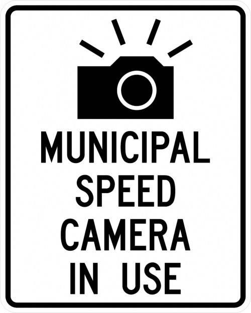 Black and white street sign that reads Municipal Speed Camera in use