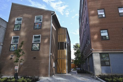 Exterior of 25 Leonard Ave. Roadway between two buildings.