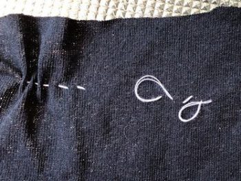 Fabric that has been sewn with a needle so tightly it has bunched up the fabric. It also shows stitches that are too loose. 