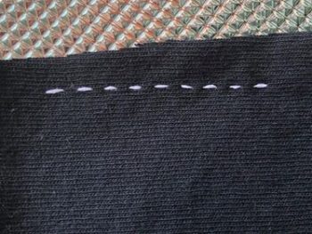 An example of properly stitched fabric from one side of the sewn material. The fabric is not bunched. 