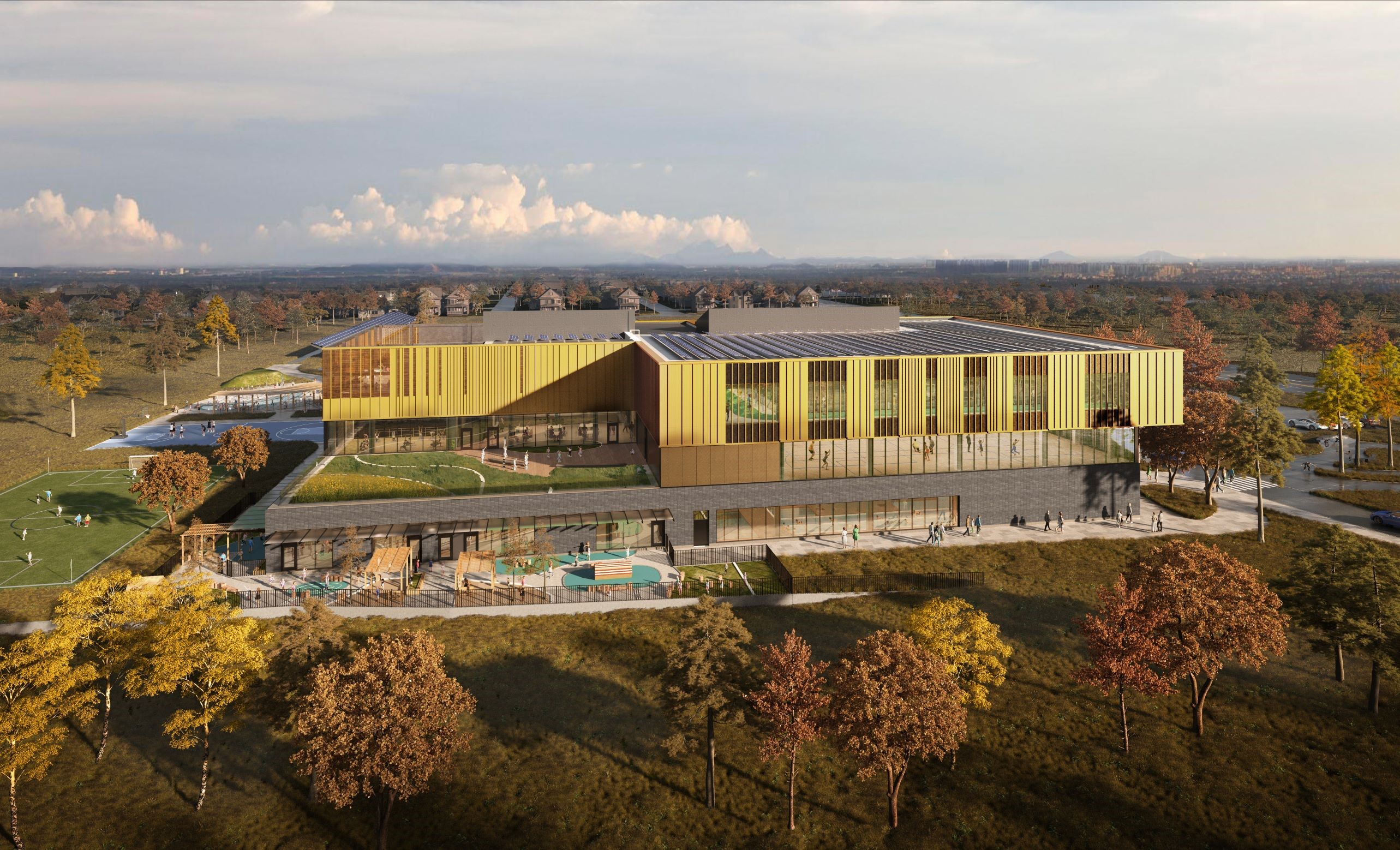 A aerial rendering of the exterior of the new North East Scarborough Community and Child Care Centre taken at a distance from the west. The image shows the area surrounding the new facility, which includes grass and mature trees.