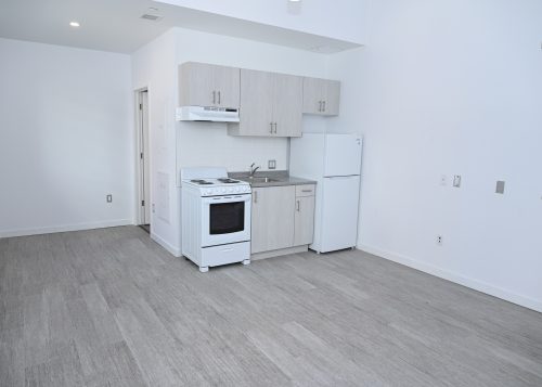 Interior of the 25 Leonard Ave. housing. Kitchen and living are.