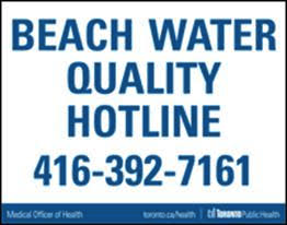A sign that says "BEACH WATER QUALITY HOTLINE 416-392-7161"