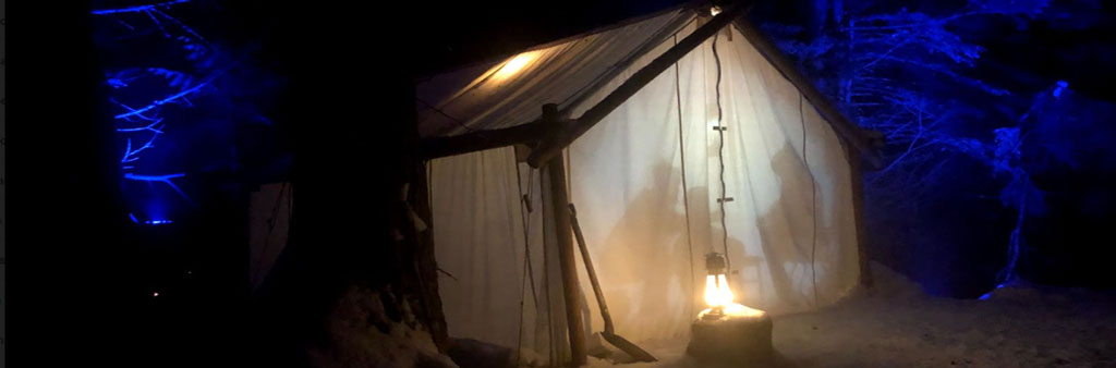 Nuit Blanche art display of silhouette of three people in a tent.