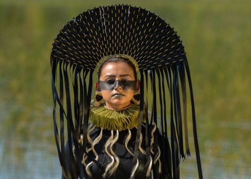 Portrait of a woman from a fashion exhibition that features the work of seven Indigenous women artists working in fashion, craft and textiles from Canada, the USA, New Zealand and Norway.