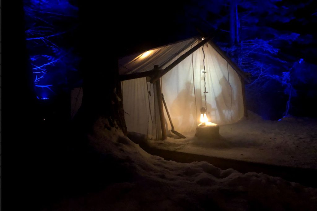 A glowing tent at night