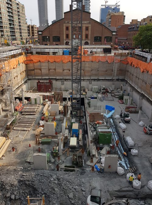 Parking Level 4 perimeter foundation walls and interior columns nearing completion. Underground geothermal system ongoing.