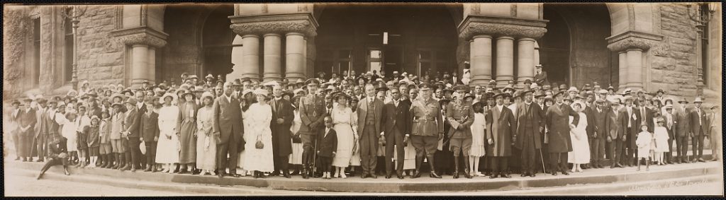 Panoramic photographic of large group of people on steps of Queen's Park