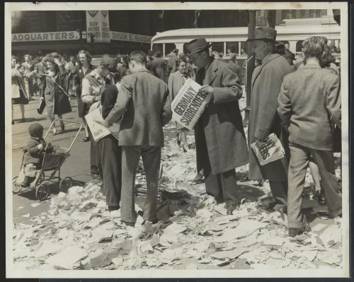 Photograph of people reading newspapers