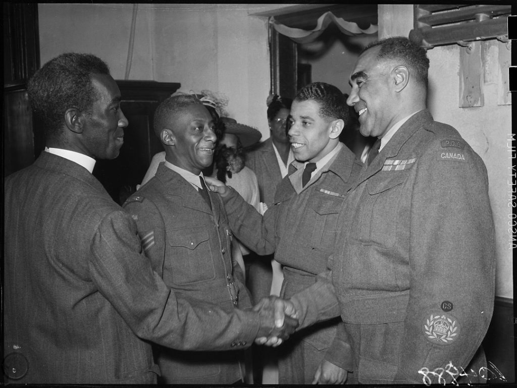 Photograph of a group of veteran soldiers being welcomed to an event