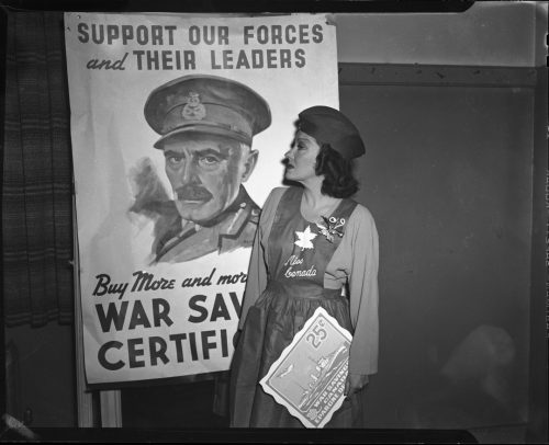 Photograph of woman posing in front of poster