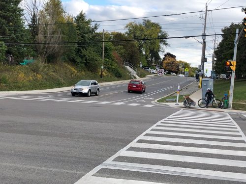 Image of Wilmington Avenue/Faywood Boulevard after the bike lane installation with painted bike lanes separated by bollards