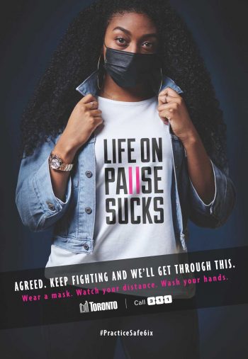 Young woman wearing a t-shirt with text that says life on pause sucks