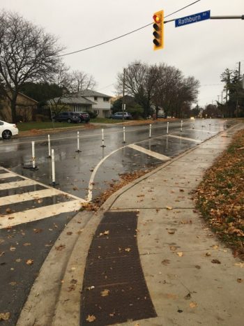 Photo showing the painted out area and bollards at the southwest corner of Martin Grove Road and Rathburn Road, looking south