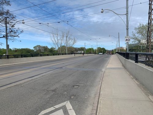 Image of Dundas Street before the bike lane installation with four lanes of traffic. 