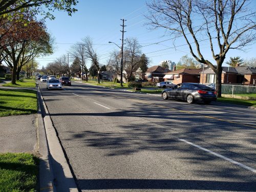 Image of Brimley Road before the bike lane installation with four lanes of traffic. 