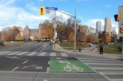 Image of University Avenue after the bike lane installation with painted bike lanes separated by bollards