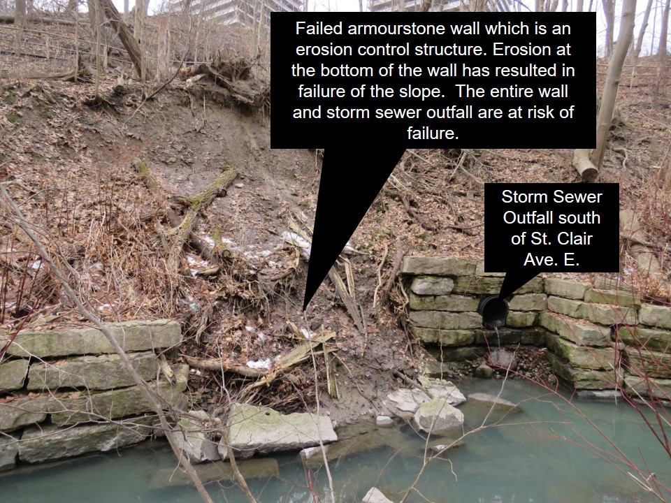 Yellow Creek storm sewer outfall south of St Clair Avenue East and a failed armourstone wall which is an erosion control structure. Erosion at the bottom of the wall has resulted in failure of the slope. the entire wall and storm sewer outfall are at risk of failure.