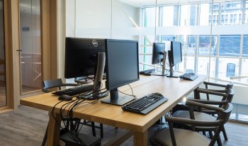 close up of computers in front of window