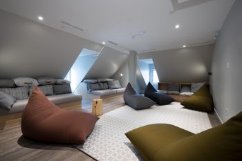 lounge with rug, bean bag chairs and benches